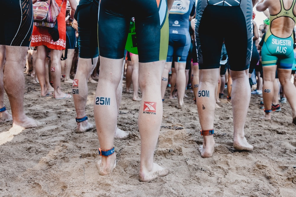 People wearing temporary tattoos at a triathlon